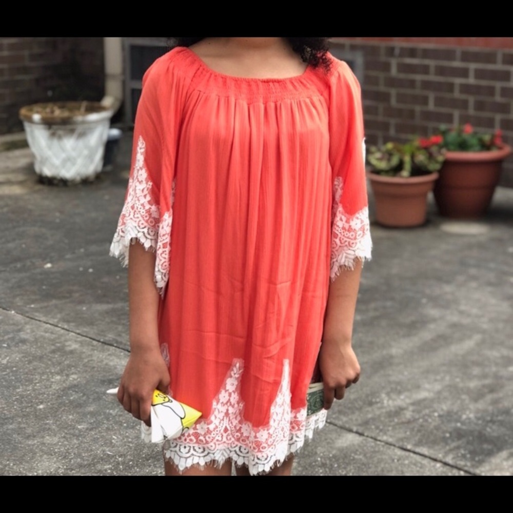 Women’s dress. Coral dress with white lace.
